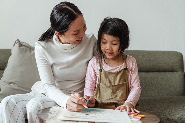 Parent teaching preschool child.