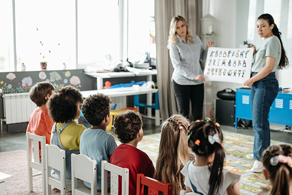 Preschool teachers educating children.