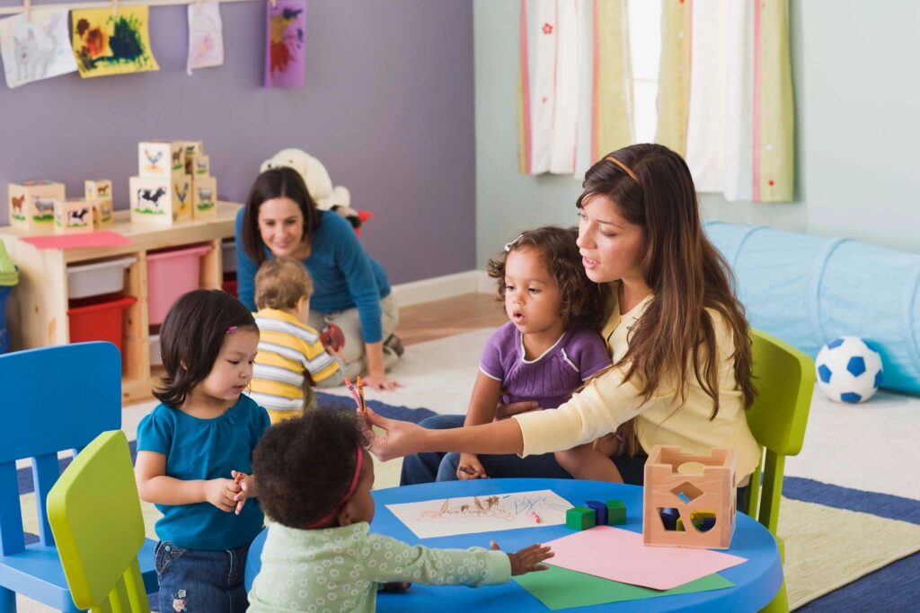 Teacher and parent in preschool classroom