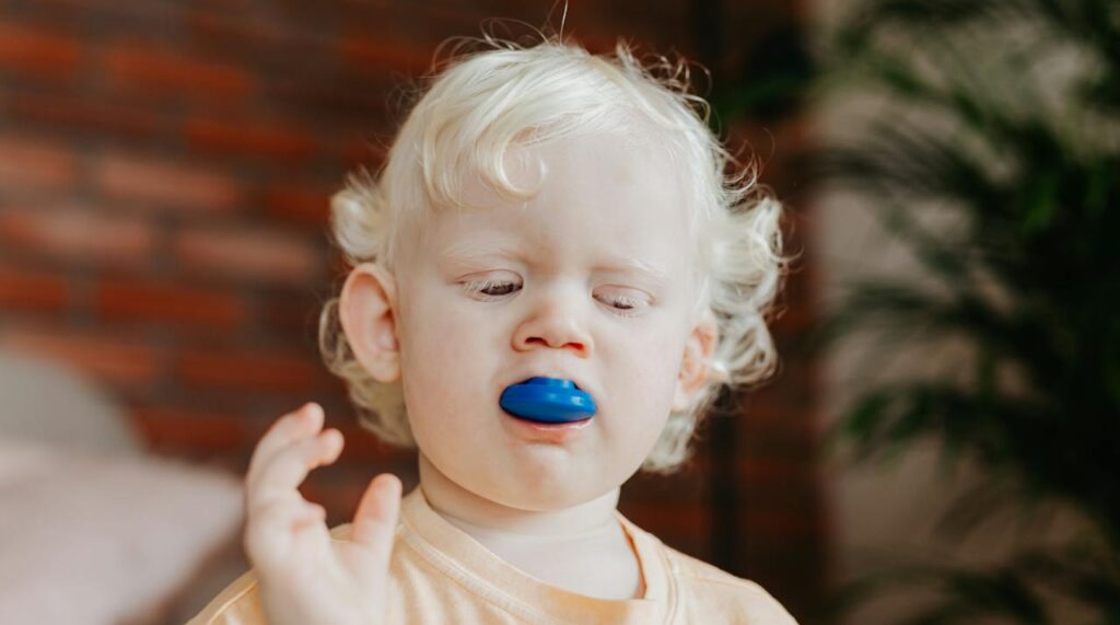 Toddler using sensory-motor skills to learn